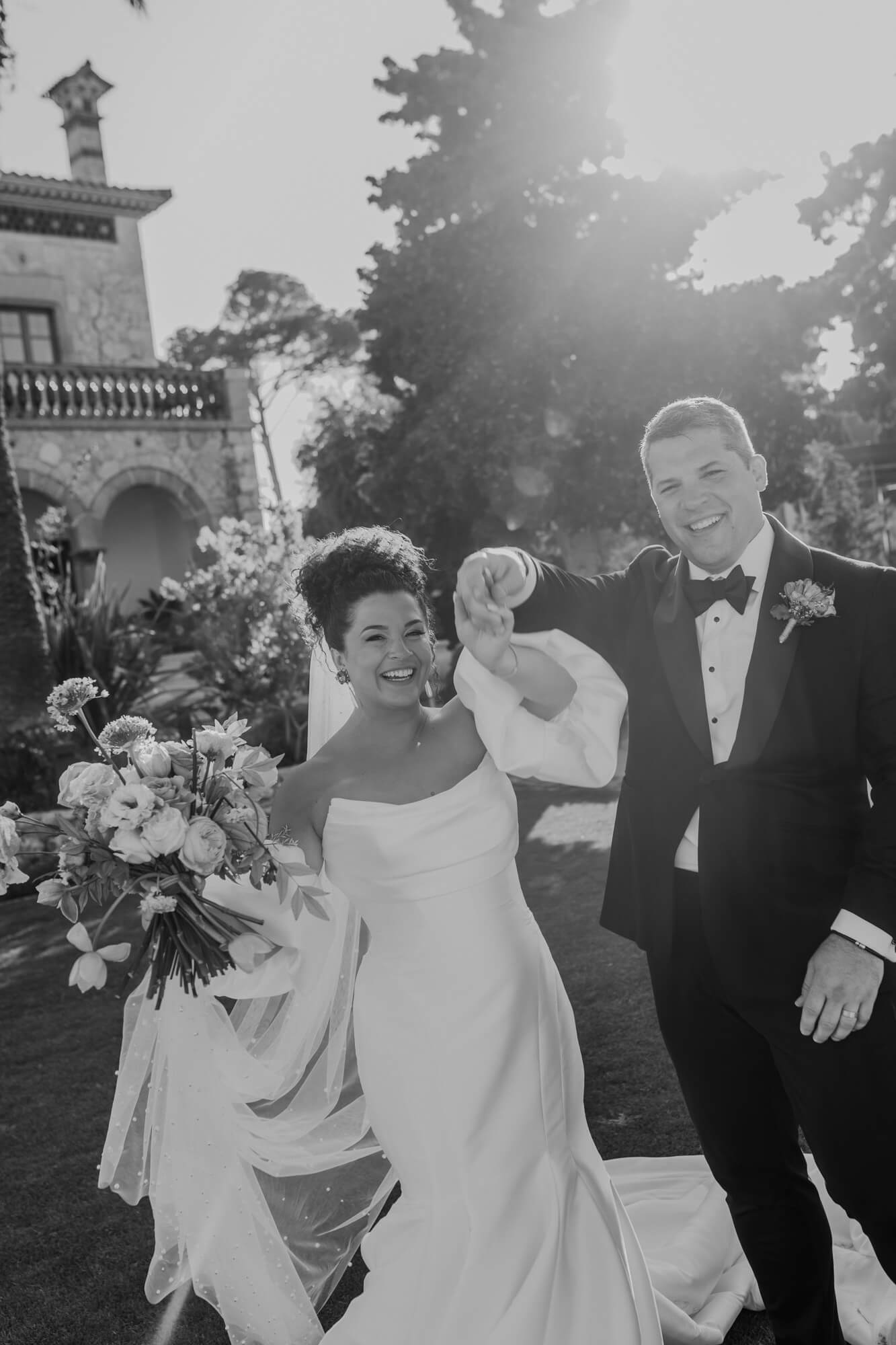 Kenzie and Lenny celebrating with a bouquet after their ceremony
