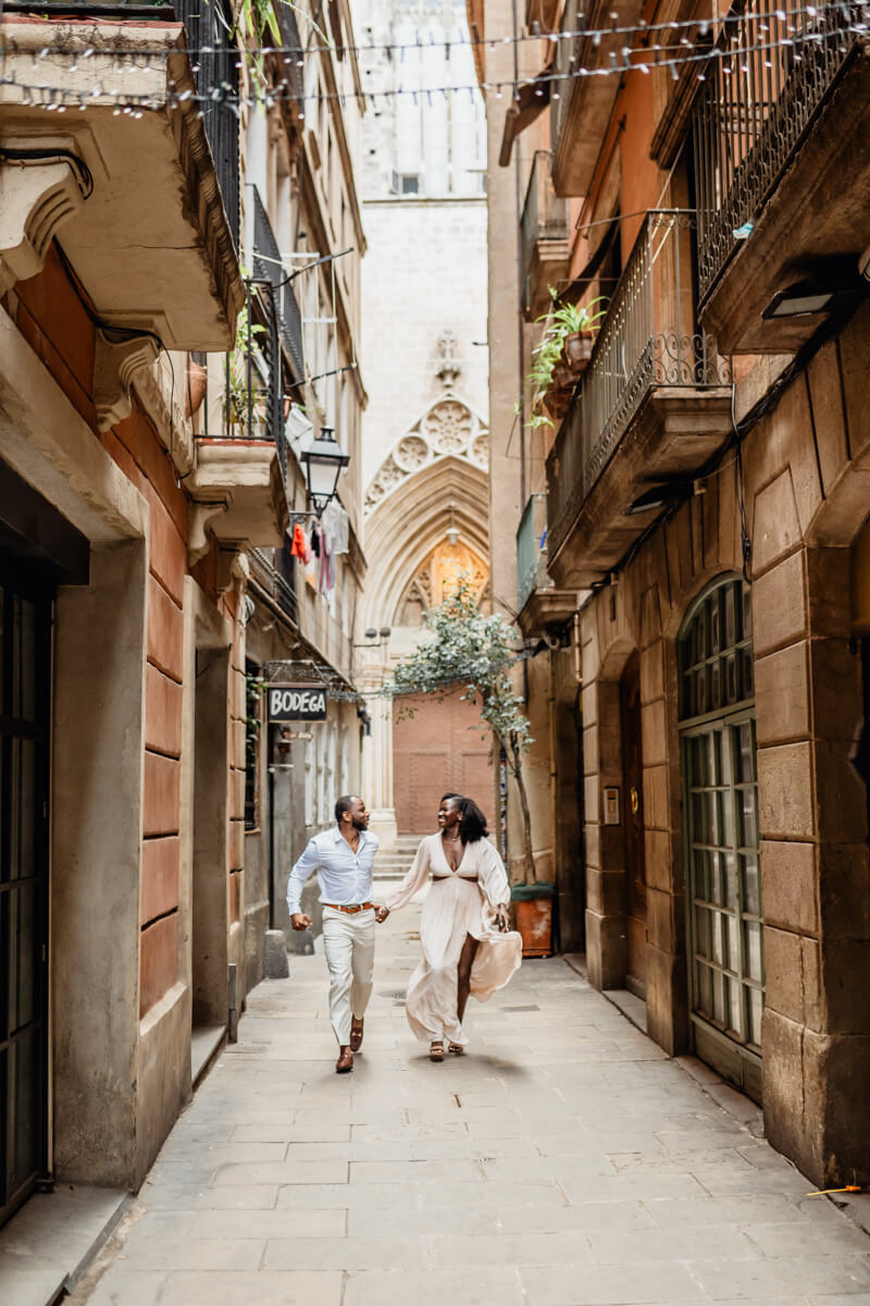 Debbie and Andritch walking hand in hand through a narrow Barcelona street